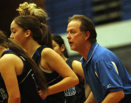 Bingham's Lady Miners coach, Rand Rassmussen, gets his team in a huddle during a game.