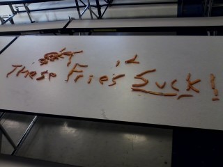 Students critique the schools sweet potato fries during lunch.