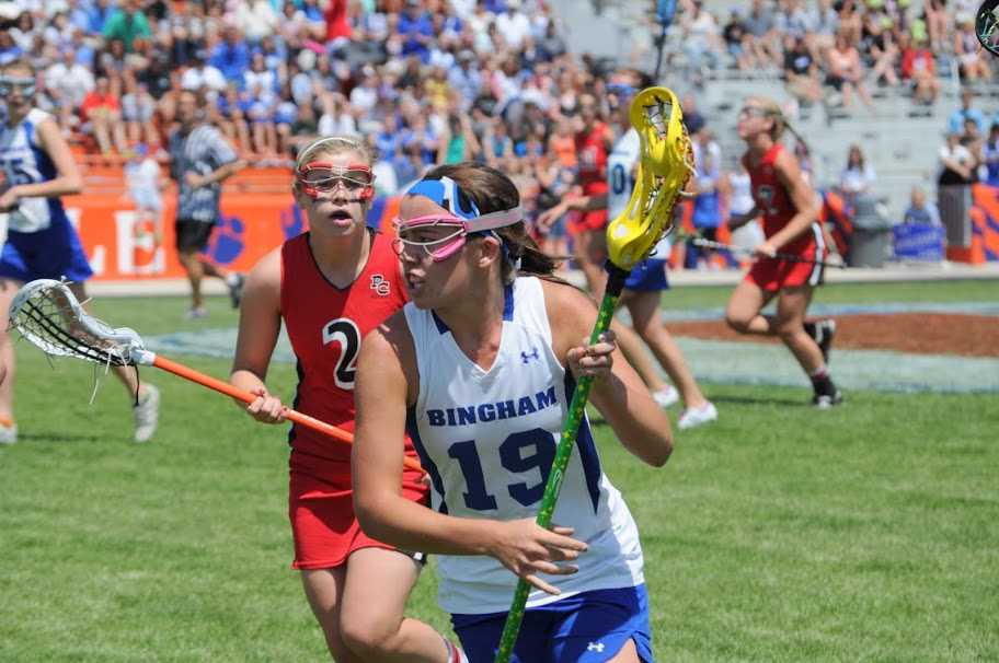 Morgan Judd (19) looks to the goal as she defends her cradle from the opposing Park City player during last year’s state championship.