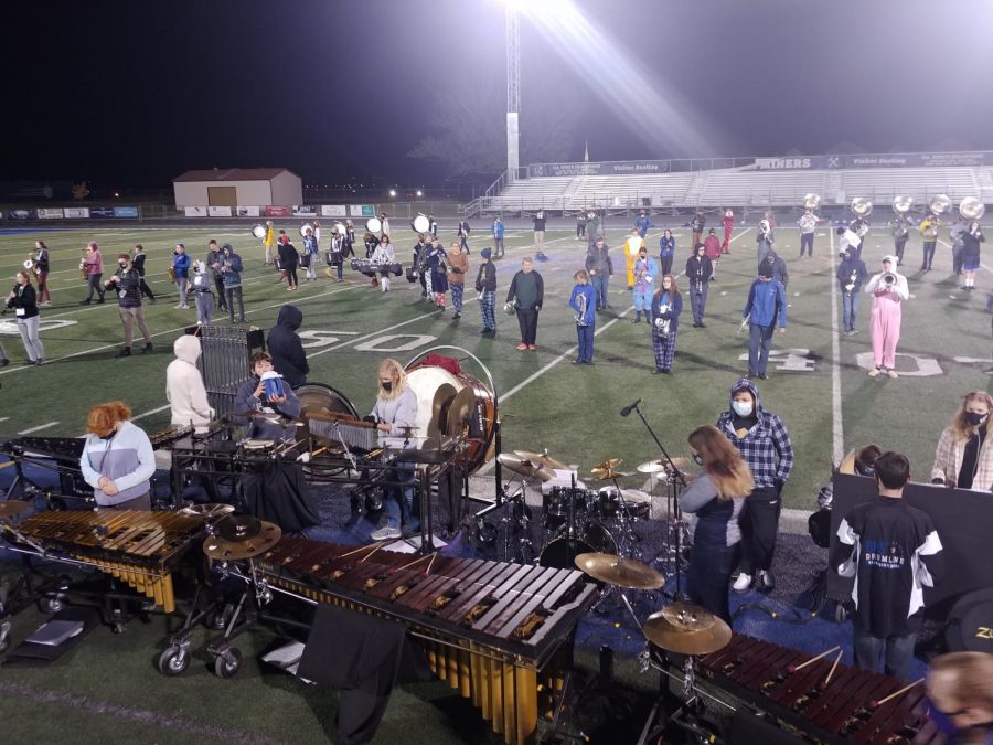 Marching band members participating in their last rehearsal before their show. 