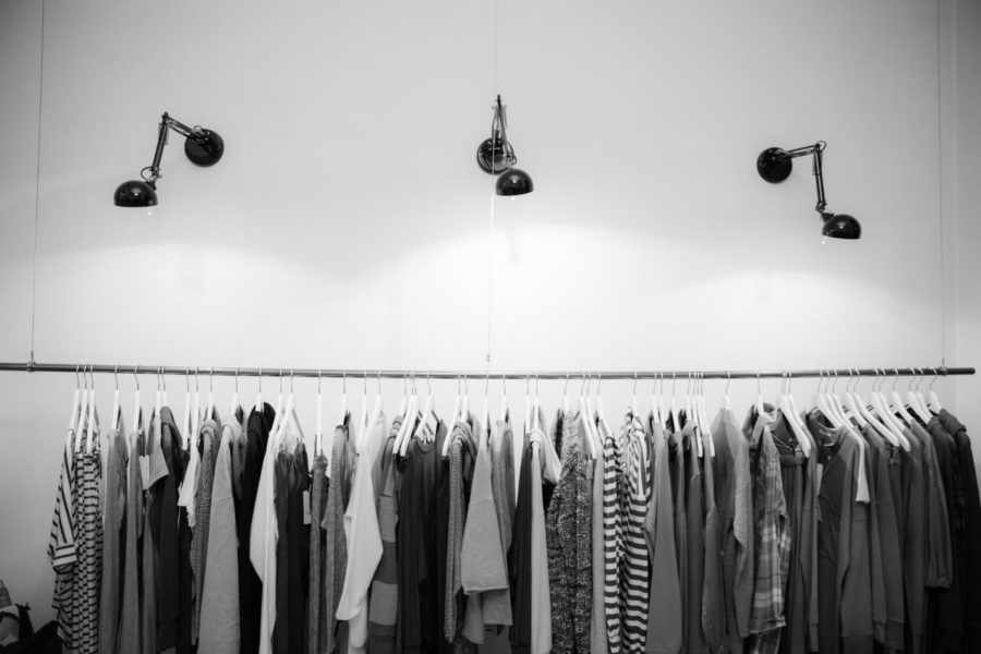 Assorted shirts hanging on a clothing rack