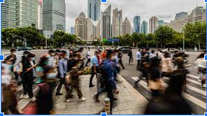 People walking a long a busy street 