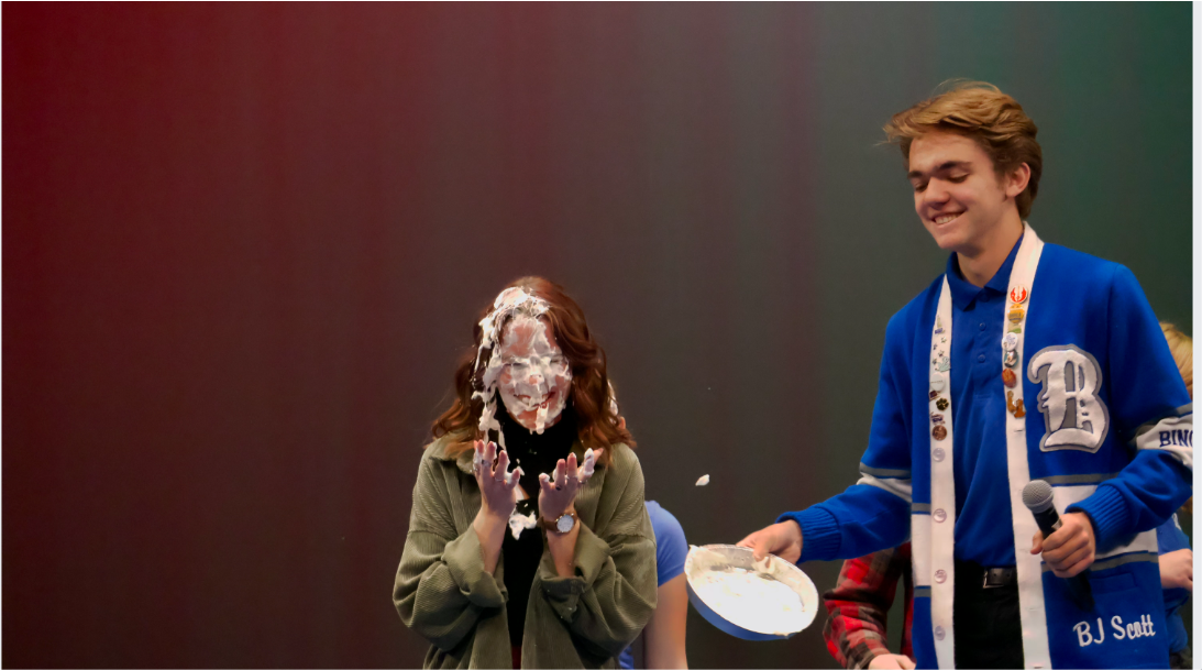 Ben Larson and Courtney Ross, members of Bingham’s improv team, playing “Hey Baby” and putting pie in each other’s faces during the True Blue Opening Assembly.